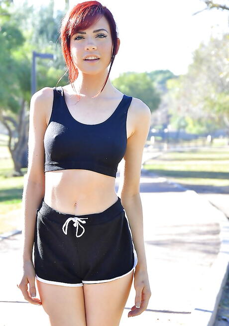 Gracile american redhead young Sabina Rouge in fancy shorts denudes tiny tits and spreads her legs outdoor